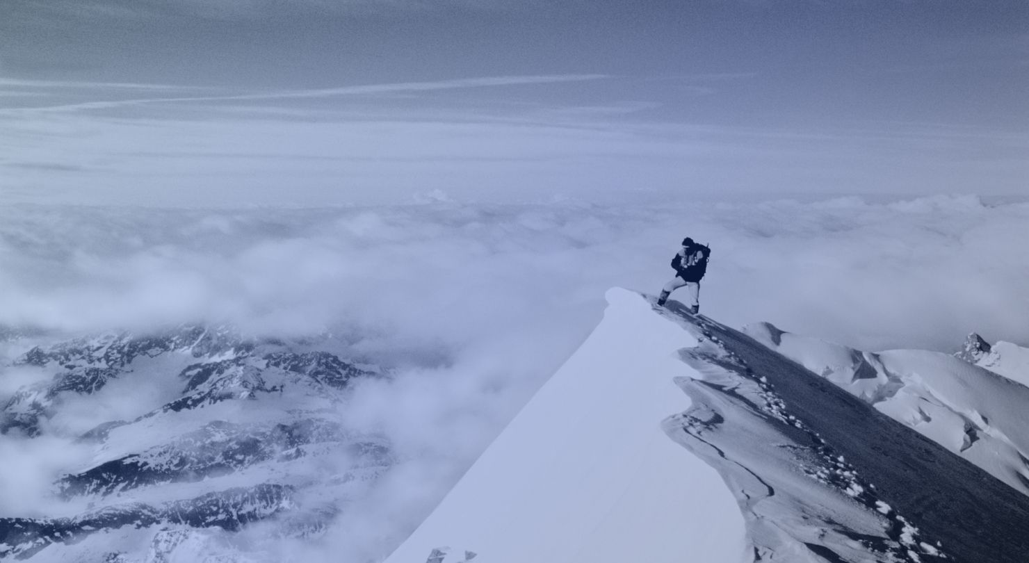 A climber on a snowy mountain ridge